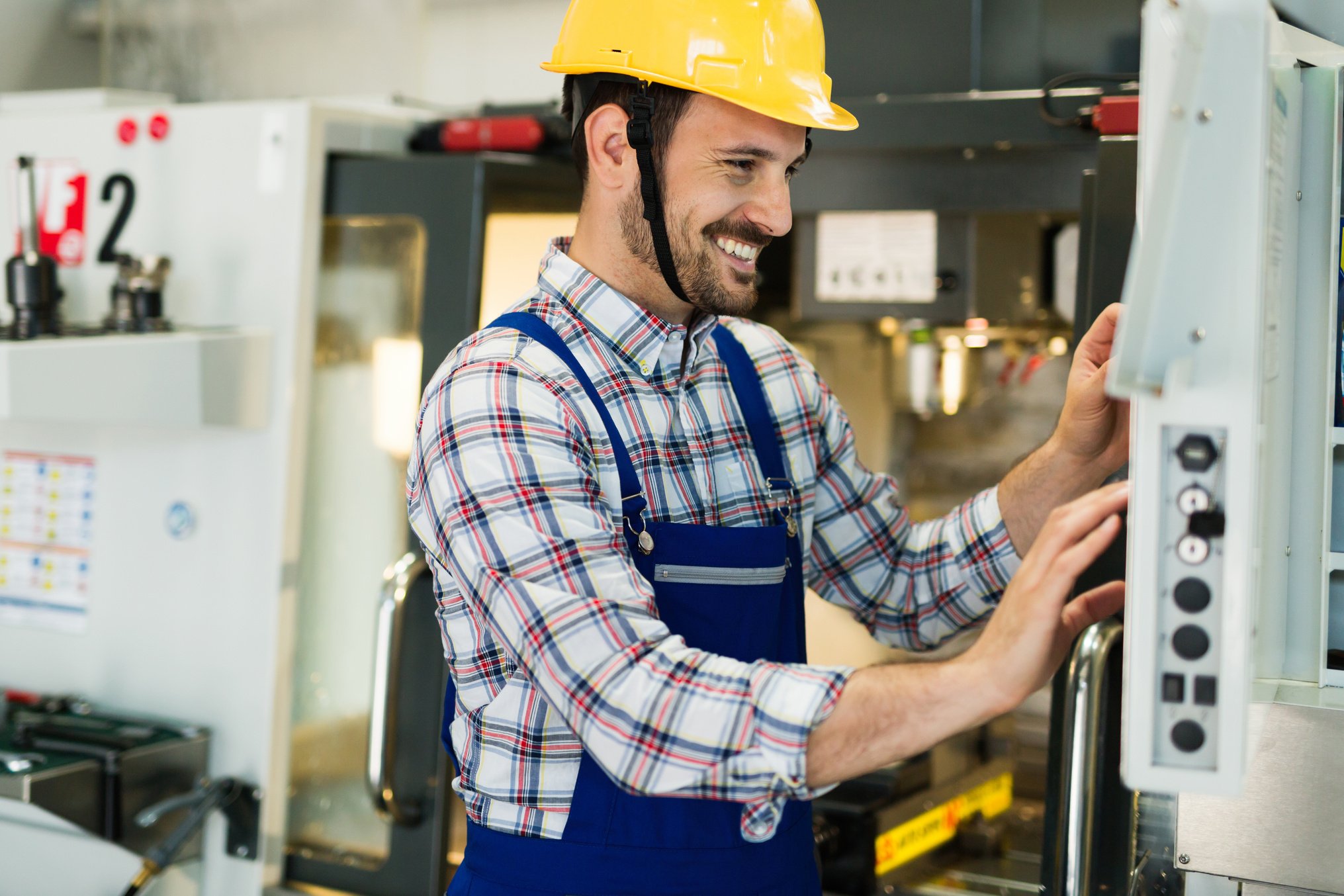 modern industrial machine operator working in factory