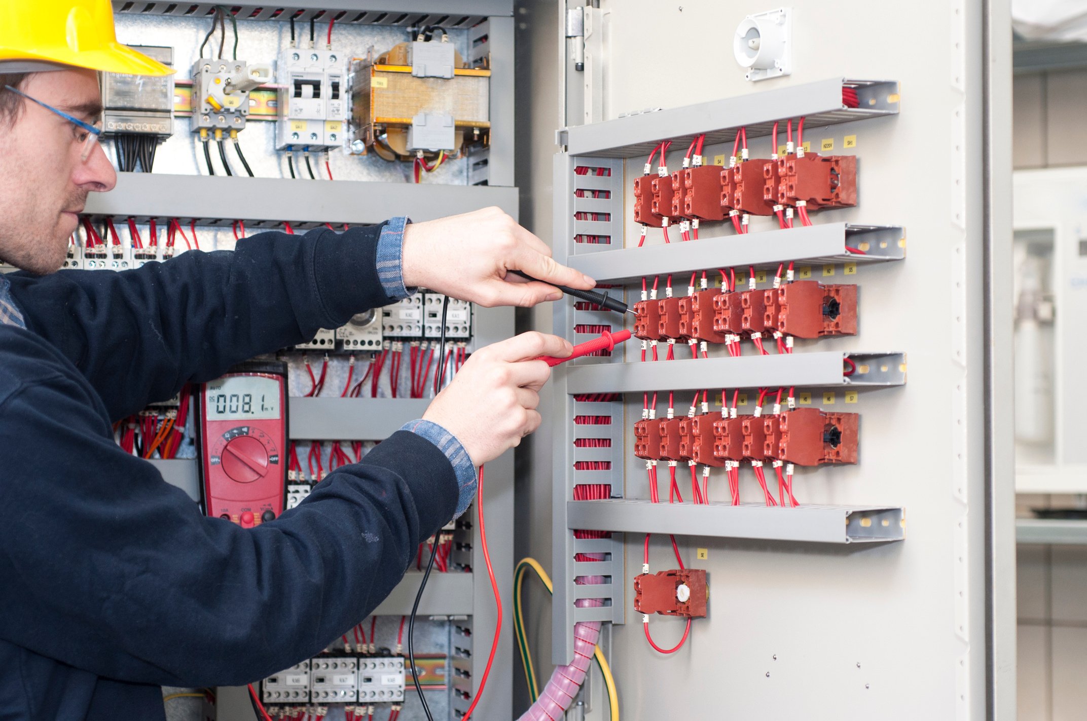 electrician testing industrial machine